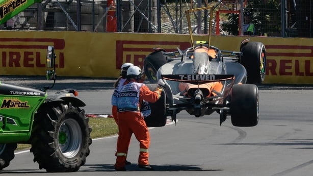 McLaren's British driver Lando Norris's car is removed from the track after an accident during the 2025 Formula 1 Grand Prix du Canada at Circuit Gilles-Villeneuve in Montreal, Canada, on June 15, 2025. (Photo by SHAWN THEW / POOL / AFP) / ALTERNATE CROP