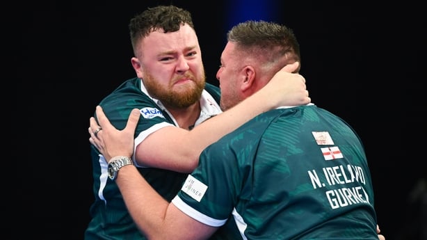 FRANKFURT AM MAIN, GERMANY - JUNE 15: Josh Rock of Northern Ireland celebrates with Daryl Gurney of Northern Ireland with the Trophy after victory in their final match on day four of BetVictor World Cup of Darts 2025 at Eissporthalle Frankfurt on June 15, 2025 in Frankfurt am Main, Germany. (Photo b