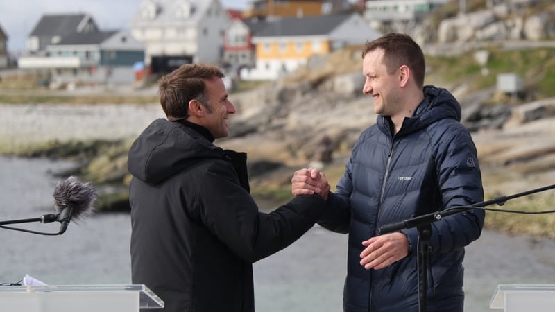 French President Emmanuel Macron shakes hands with Greenland's Prime Minister Jens-Frederik Nielsen at the end of a joint press conference in Nuuk, Greenland