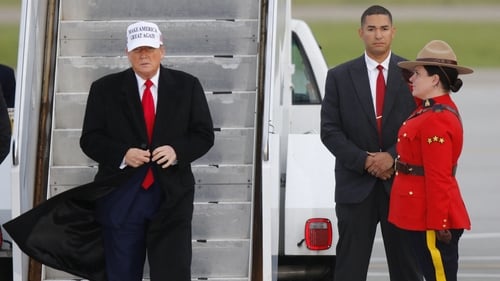 US President Donald Trump steps off of Air Force One upon arrival at Calgary International Airport
