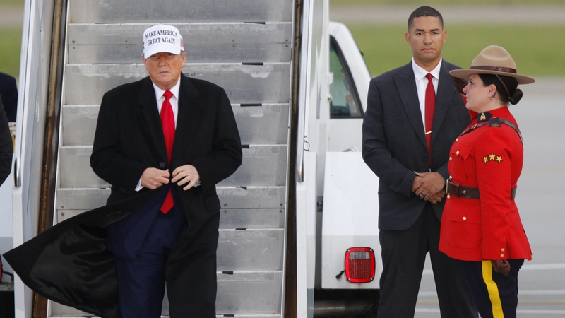 US President Donald Trump steps off of Air Force One upon arrival at Calgary International Airport