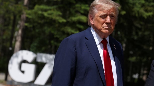 US President Donald Trump speaks to reporters with the British prime minister (out of frame) during the Group of Seven (G7) Summit at the Pomeroy Kananaskis Mountain Lodge in Kananaskis, Alberta, Canada on June 16, 2025. US President Donald Trump was leaving a Group of Seven summit early on Monday a
