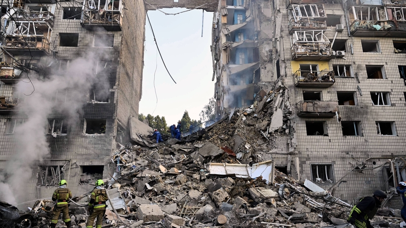 Ukrainian rescuers conduct a search and rescue work in a heavily damaged residential building following the Russian missile strike in Kyiv
