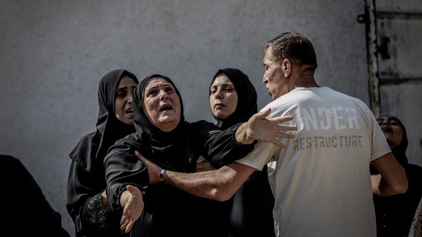 GAZA CITY, GAZA - JUNE 17: Relatives of the Palestinians killed in Israeli attacks on Rashid Street, mourn as the bodies are taken to Al-Shifa hospital for funeral procedures in Gaza City, Gaza on June 17, 2025. (Photo by Saeed M. M. T. Jaras/Anadolu via Getty Images)