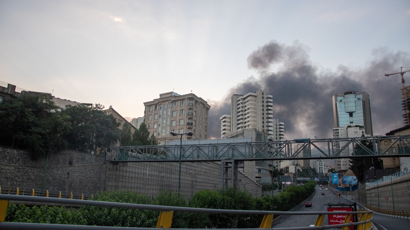 Smoke billows over the building housing Iran's state media, which was hit in an Israeli strike