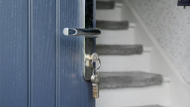 Opened front door, staircase in the background