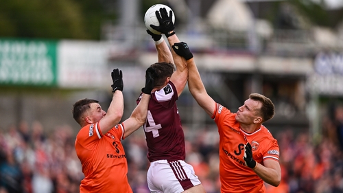 Galway's Shane Walsh competes in the air with Armagh's Peter McGrane, left, and Rian O'Neill, right