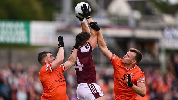 Galway's Shane Walsh competes in the air with Armagh's Peter McGrane, left, and Rian O'Neill, right