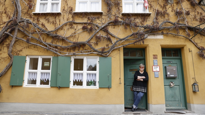 Martha Jesse is seen at the front door of her home in the Fuggerei in Augsburg