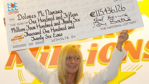 a person holding a large check