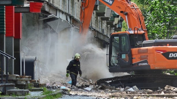 KYIV, UKRAINE - 2025/06/18: An excavator seen clearing debris, as a rescuer continues a search operation at the site that was heavily damaged following Russian missile strikes amid the Russian invasion of Ukraine. In the early morning of June 17, the Russian army attacked the Ukrainian capital with