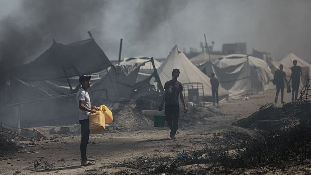 An aid truck arrives in the camp and distributes water to displaced Palestinians, on June 19, 2025 in Gaza City, Gaza. Palestinians in Gaza City, whose infrastructure has been severely damaged as a result of Israeli attacks, are having difficulty accessing clean drinking water. Most of the populatio