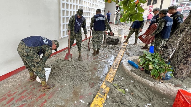 Mexican navy members repair a footpath following the passage of the hurricane in Puerto Escondido in the state of Oaxaca