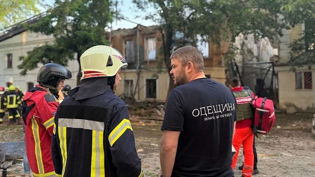 ODESA, UKRAINE JUNE 17: (----EDITORIAL USE ONLY - MANDATORY CREDIT - 'ODESA REGIONAL MILITARY ADMINISTRATION OF UKRAINE / HANDOUT' - NO MARKETING NO ADVERTISING CAMPAIGNS - DISTRIBUTED AS A SERVICE TO CLIENTS---- ) Residents stand in front of a heavily damaged residential building as emergency crews