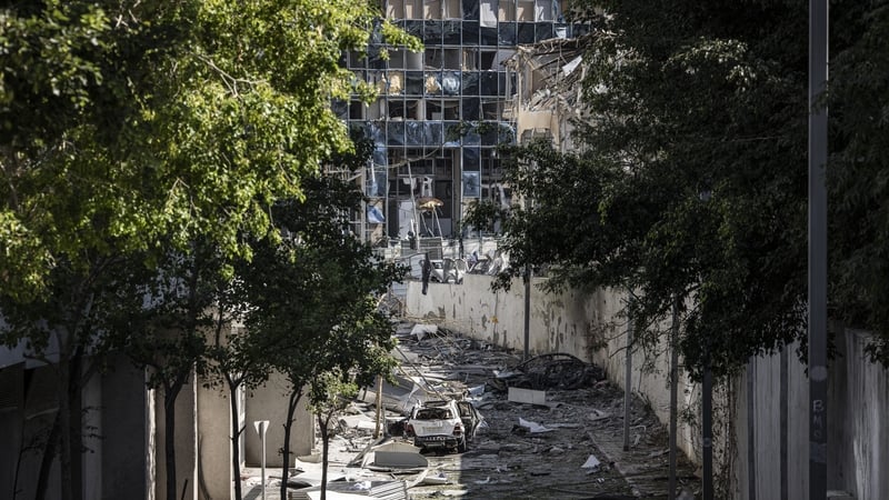 Debris fills a street a day after an Iranian missile struck an area in Ramat Gan, Israel