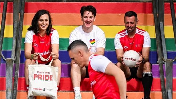 18 June 2025; Carry With Pride! Pictured is content creator, footballer and LGBTQ+ advocate Kevin Penrose, centre, alongside, GAA referee, David Gough and Cork LGFA Camogie player, Hannah Looney watching Armagh footballer Mark Shields to officially launch SuperValu's new limited-edition Pride themed