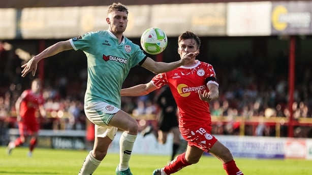Derry City's Ronan Boyce, left, is challenged by John Martin of Shelbourne