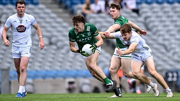 Fermanagh midfielder Joe McDade is chased by Kildare captain Kevin Feely
