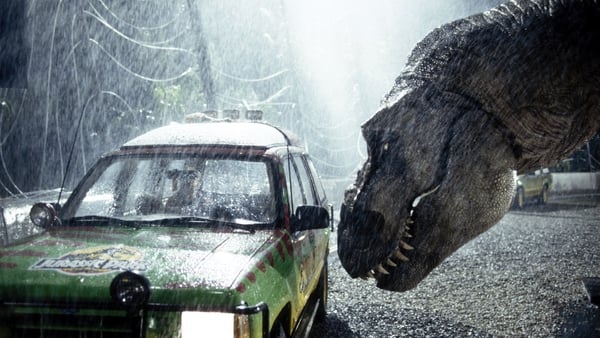A tyrannosaurus rex terrorizes people trapped in a car in a scene from the 1993 American film Jurassic Park directed by Steven Spielberg.