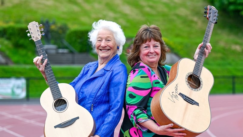 Mary Peters and Julie Hastings with guitars from Ed Sheeran (left) and Van Morrison