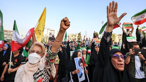 Iranians cheer as they celebrate a ceasefire between Iran and Israel at Enghlab Square in the capital Tehran