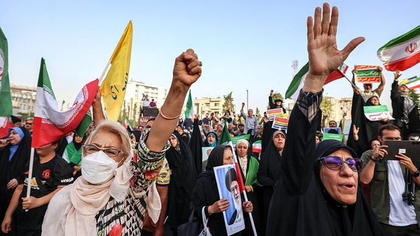 Iranians cheer as they celebrate a ceasefire between Iran and Israel at Enghlab Square in the capital Tehran