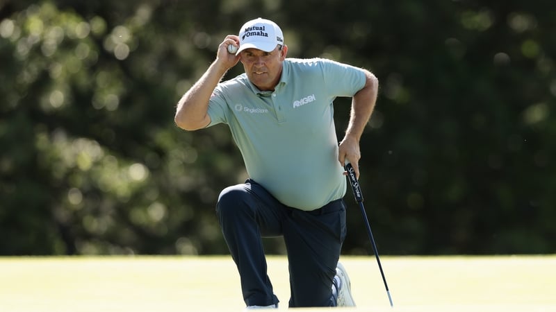 Padraig Harrington lines up a putt on the 11th green during the first round