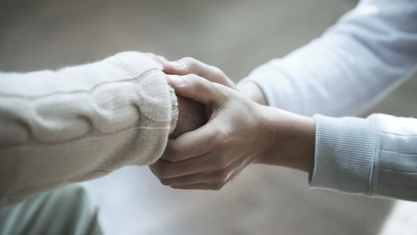 stock image of two people holding hands