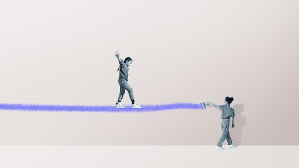Girl painting blue ramp for friend walking against colored background