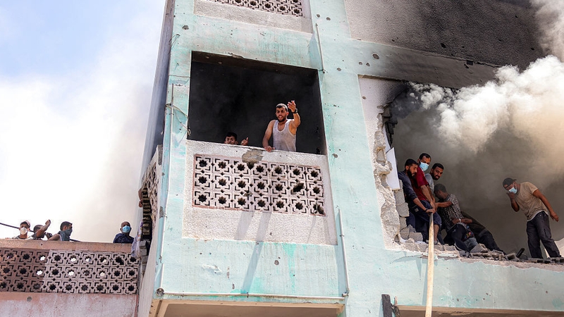 First-responders attempt to extinguish a blaze following an Israeli strike in Gaza