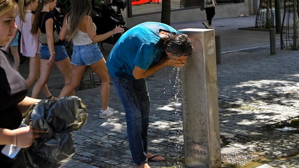 ATHENS, GREECE - JUNE 27: A man refreshes with water on June 27, 2025 in Athens, Greece. People in Greece are experiencing the first major heatwave of the summer, with sweltering temperatures expected through Friday. (Photo by Milos Bicanski/Getty Images)