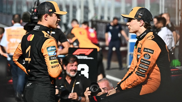 Pole position winner McLaren's British driver Lando Norris (L) speaks with team mate third placed McLaren's Australian driver Oscar Piastri after the qualifying session at the Red Bull Ring race track in Spielberg, Austria, on June 28, 2025, ahead of the Formula One Austrian Grand Prix. (Photo by Jo