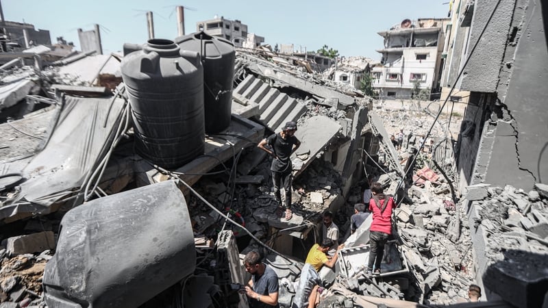 Civil defence teams conduct a rescue operations after an Israeli attack in Gaza City