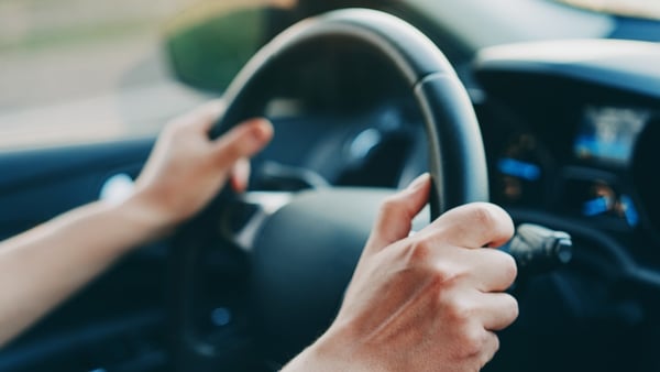 Male hands holding steering wheel in a car Male hands holding steering wheel in a car