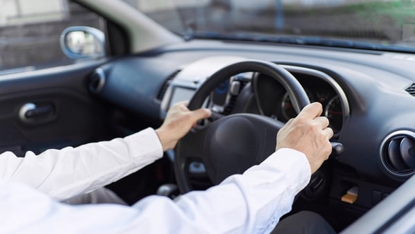 A man drives a right-hand drive car