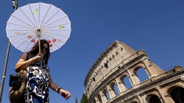 ROME, ITALY - JUNE 30: Tourists use an umbrella to avoid sun as heat wave is effective in Rome, Italy on June 30, 2025.e, Italy on June 30, 2025.ratures. (Photo by Pablo Esparza/Anadolu via Getty Images)
