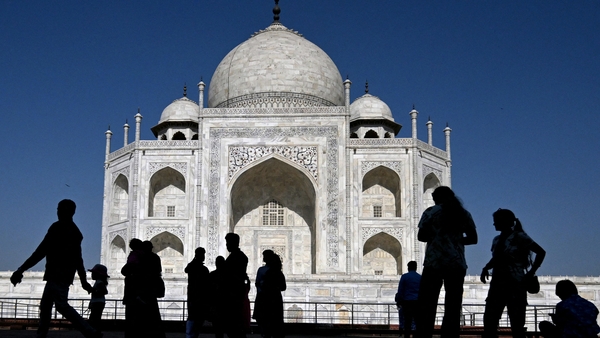 Tourists visit the Taj Mahal in Agra on April 23, 2025
