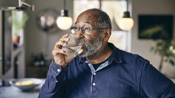 a person drinking from a glass