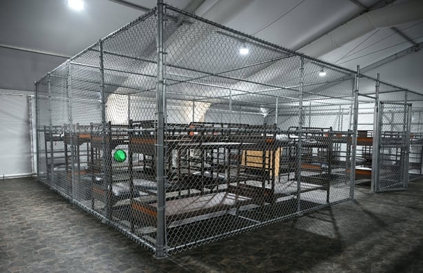 Beds are seen inside a migrant detention center, dubbed "Alligator Alcatraz," located at the site of the Dade-Collier Training and Transition Airport, as US President Donald Trump tours the facility in Ochopee, Florida on July 1, 2025. President Trump is visiting a migrant detention center in a rept
