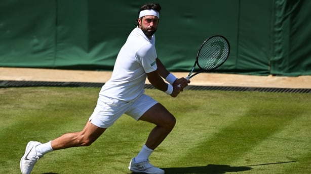 Nikoloz Basilashvili of Georgia in action against Lorenzo Musetti of Italy during the Men's Singles First Round match on day two of The Championships Wimbledon 2025 at All England Lawn Tennis and Croquet Club on July 01, 2025 in London, England.