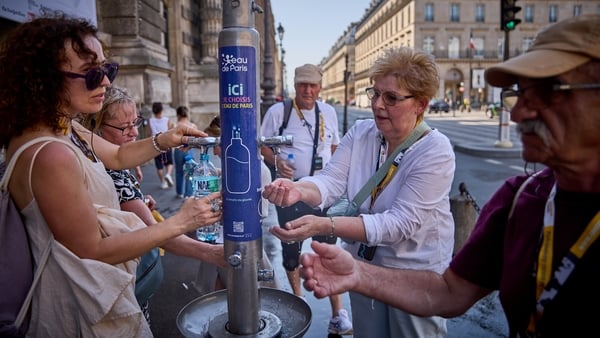 PARIS, FRANCE - JULY 01: People use a public fountain on the Rue de Rivoli to cool off from the heat of the day as Paris experiences temperatures of up to 44°C on July 01, 2025 in Paris, France. The French weather agency Météo France has placed Paris and