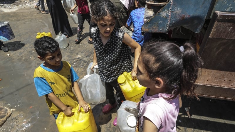 Displaced Palestinians in Gaza City try to meet their daily water needs by filling cans with water delivered by tankers