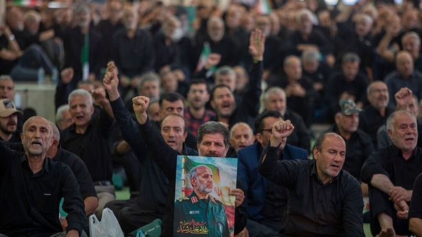 TEHRAN, IRAN - JULY 2: People raise their fists during a memorial ceremony held for those killed in Israeli airstrikes, at the Imam Khomeini Mosque, on July 2, 2025 in Tehran, Iran. According to Iranian officials, at least 935 people were killed in Iran during the 12 day aerial conflict with Israel 