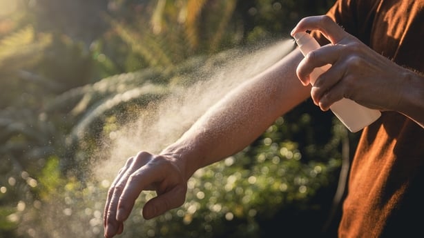 Man while applying insect repellent on his hand. Prevention against mosquito bite in tropical destination.