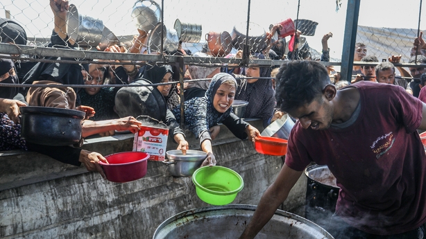 KHAN YUNIS, GAZA - JULY 03: Palestinians gather for receive food on July 03, 2025 in Khan Yunis, Gaza. Thousands of Palestinians are struggling with hunger due to Israeli attacks on Gaza and the lack of humanitarian aid. In Khan Yunis, a charity organization distributed food to displaced Palestinian