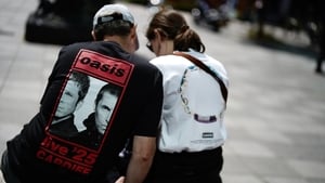 Oasis fans wearing band t-shirts outside the Principality Stadium
