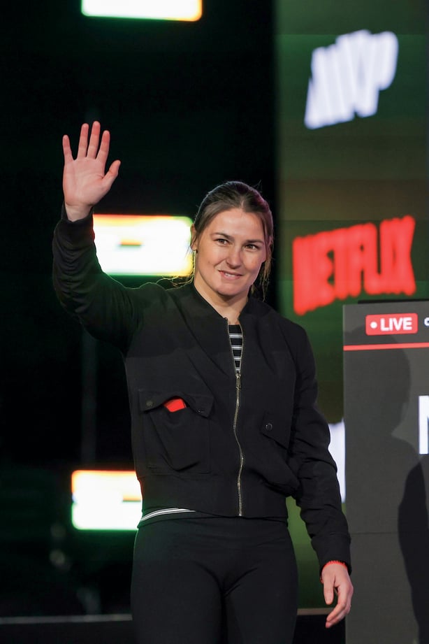 Katie Taylor waves to photographers while attending the Katie Taylor vs. Amanda Serrano Press Conference 