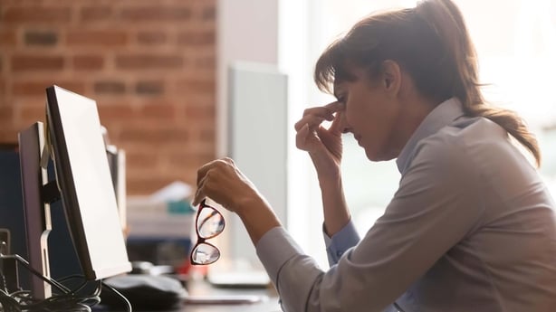 a person holding her glasses