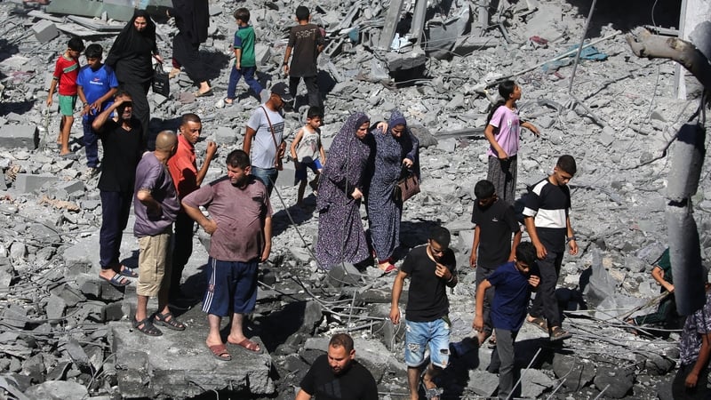 Palestinians inspect the damage after an Israeli strike in the Al-Bureij camp in central Gaza yesterday