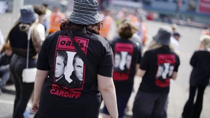 Oasis fans wearing band t-shirts outside the Principality Stadium, Cardiff